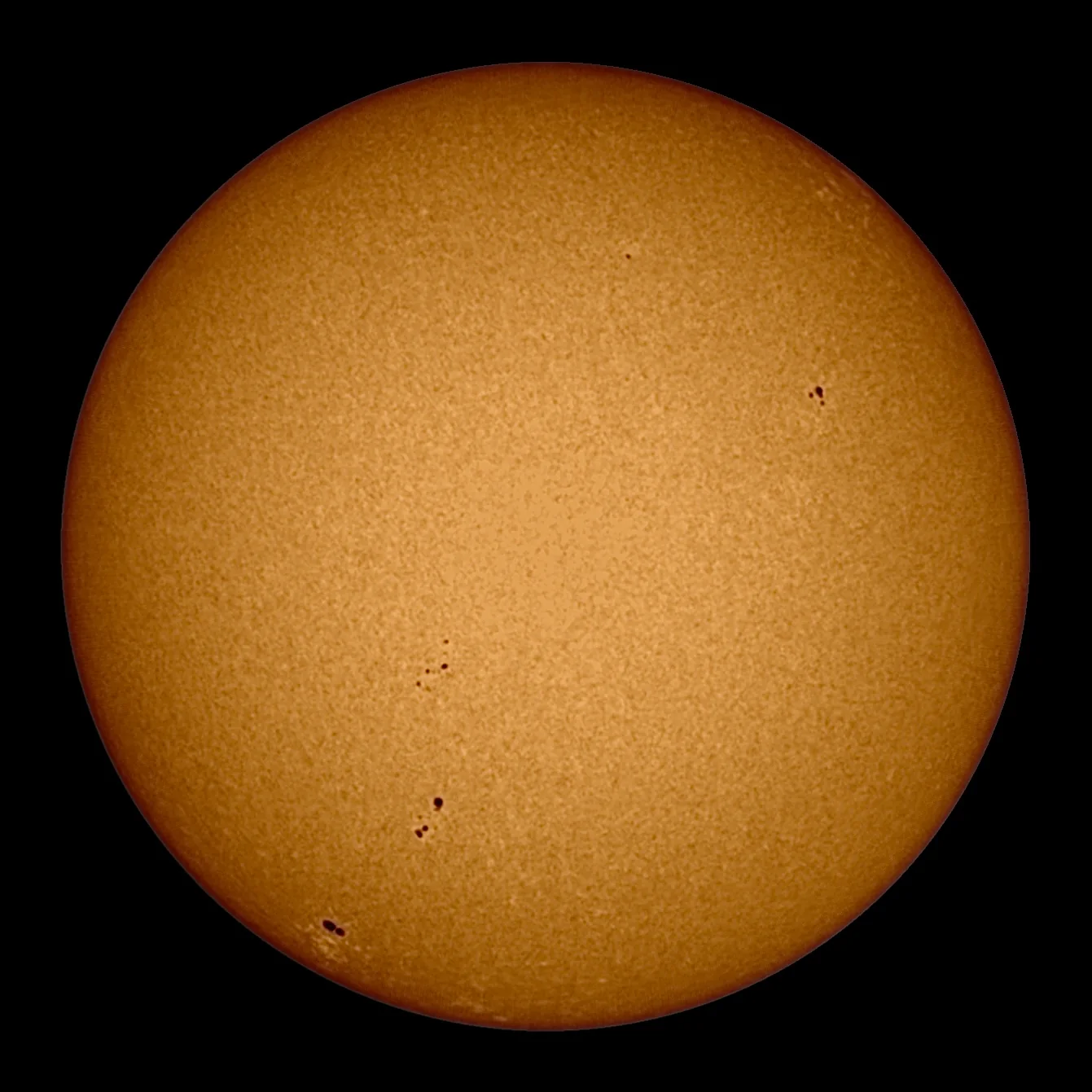 The Sun in white light: an orange disc of fine granulation with groups of dark sunspots