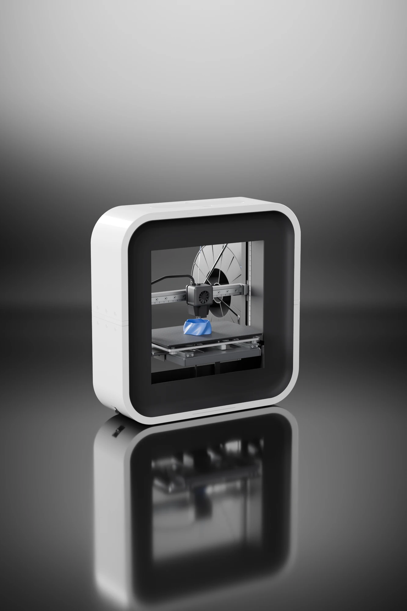 The BEETHEFIRST printer in a dark studio: a white ring with a black recess around a window, printing a blue part