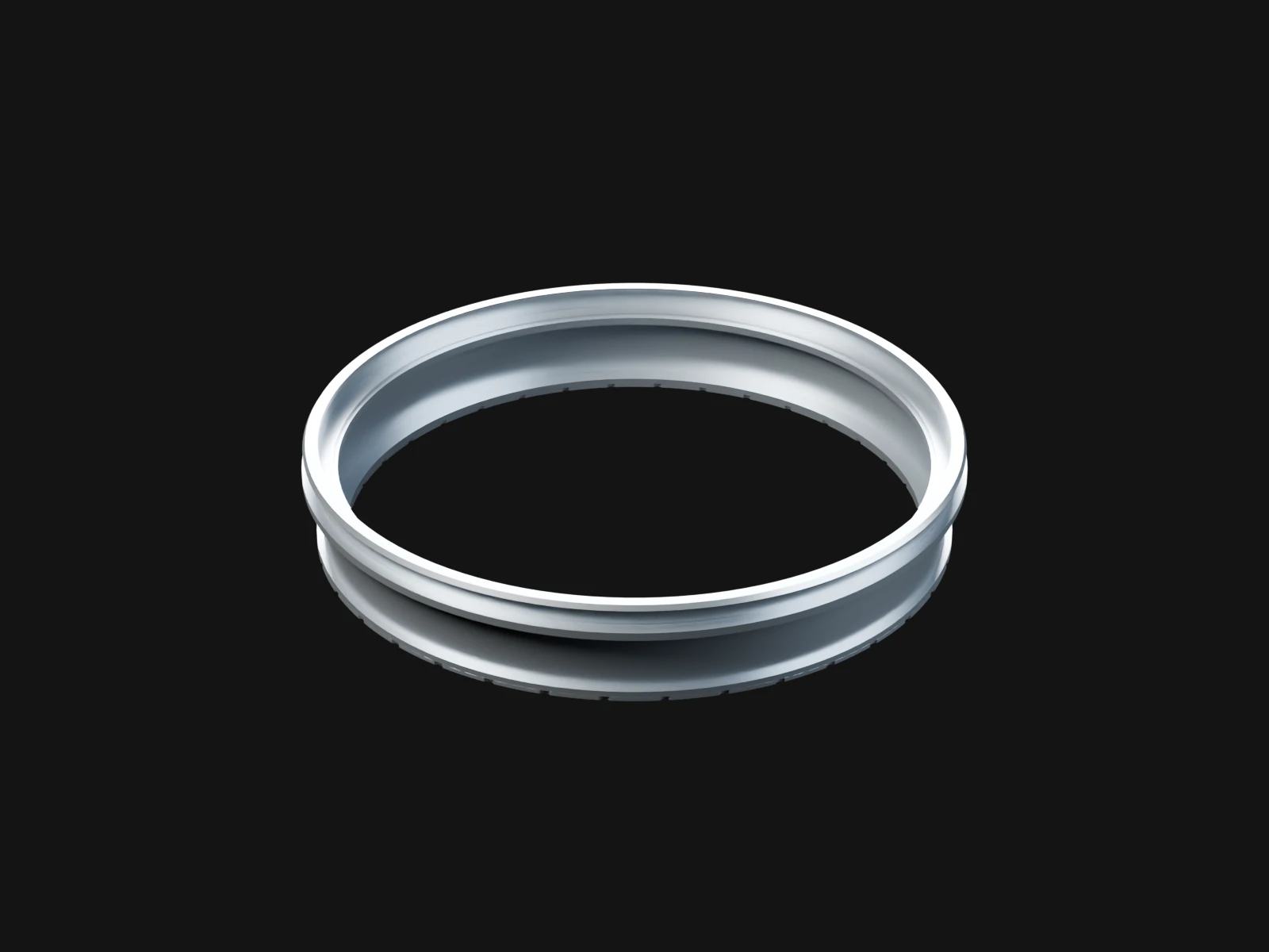 A silver ring with a thinner machined ring on its top flange, standing on a flat scalloped doubler