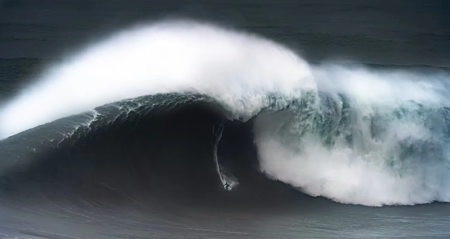 A surfer on a giant wave at Nazaré