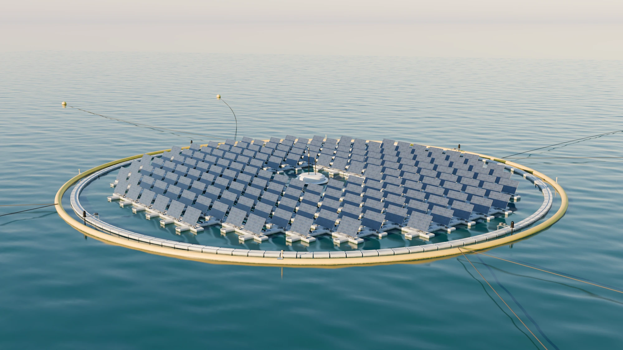 The reconstructed island seen from a low angle over calm water: 180 tilted modules in a disc, a white inner ring, a yellow outer ring and mooring lines running out to buoys
