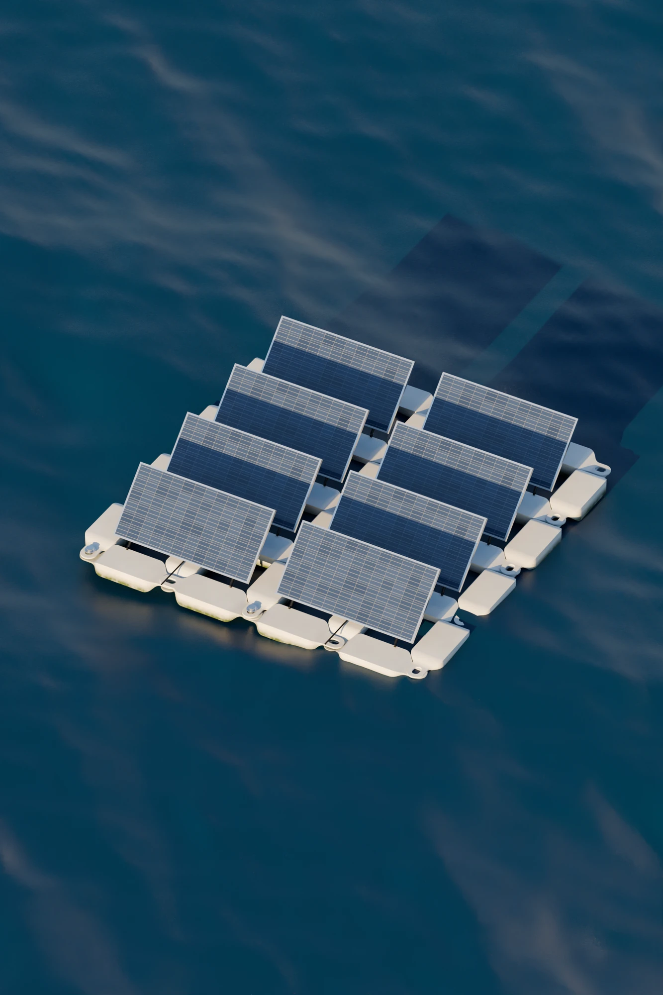 The Protevs raft of eight tilted solar panels on white floats, seen from above on a deep blue sea with the low sun glinting on the waves