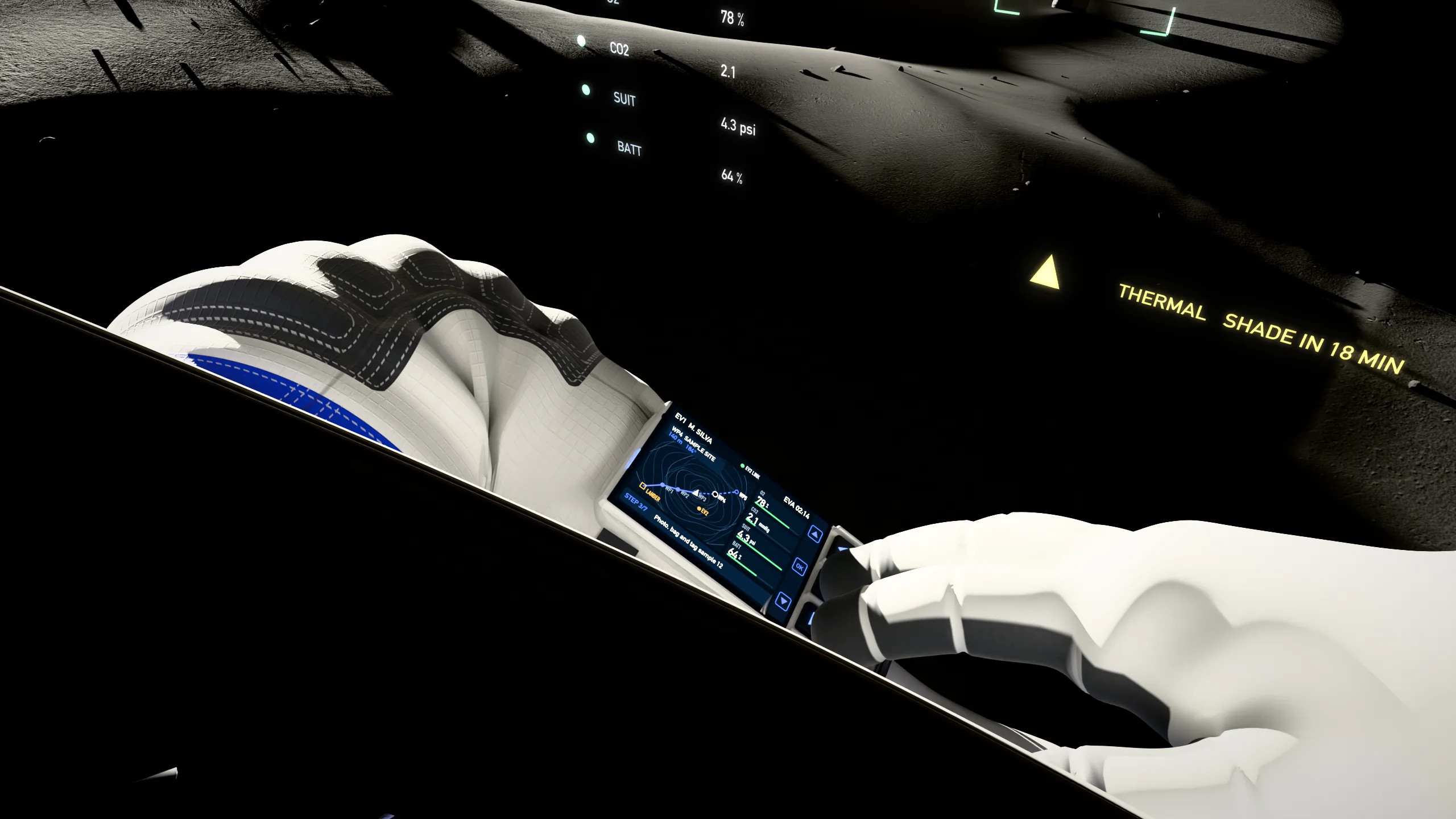 View from inside the helmet looking down at the forearm screen and the other glove, with the head-up display still fixed to the visor above