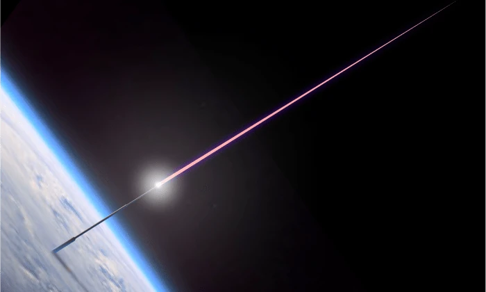 The same tower firing a pink laser beam from its tip into black space